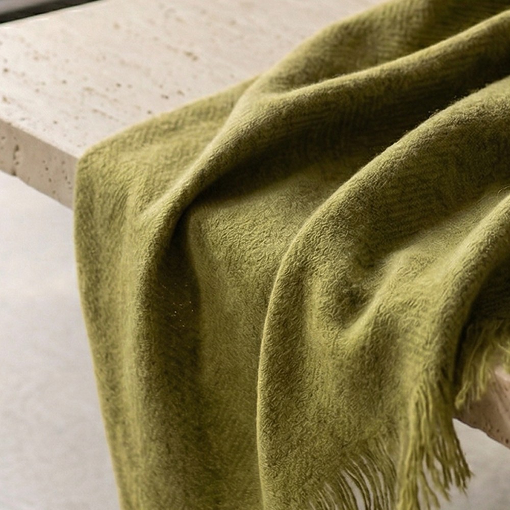 Olive scarf draped over a stone bench
